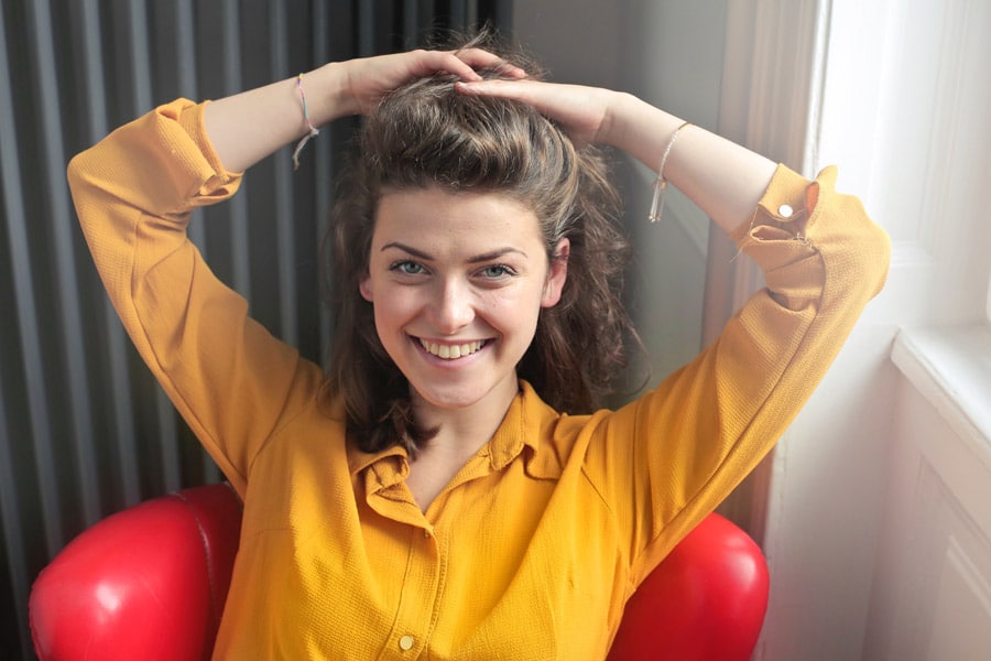 Smiling young woman with voluminous, contoured cheeks