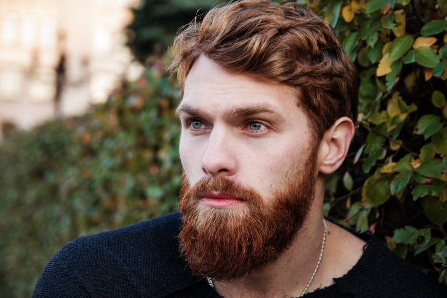 A man with a well-defined brow and forehead looking away from the camera