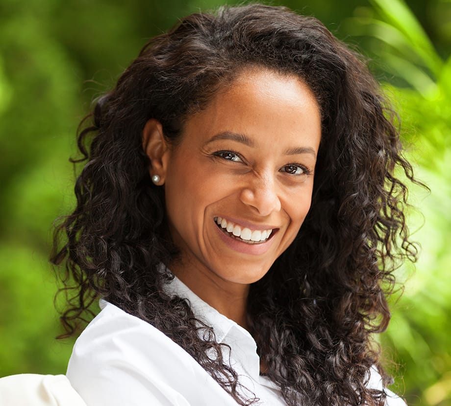 Woman smiling while sitting outside