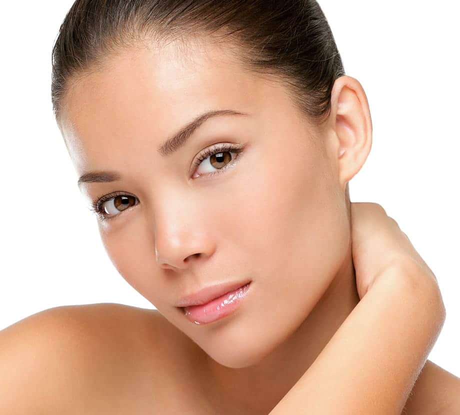 Close up of woman's face as she holds her neck with her hand