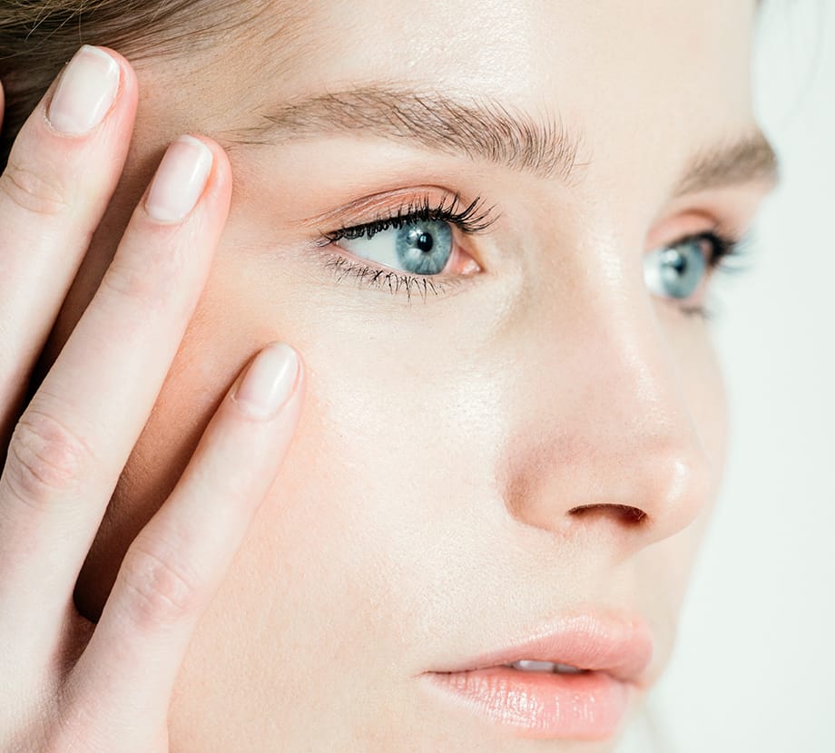 Up close picture of woman with her hand on her face