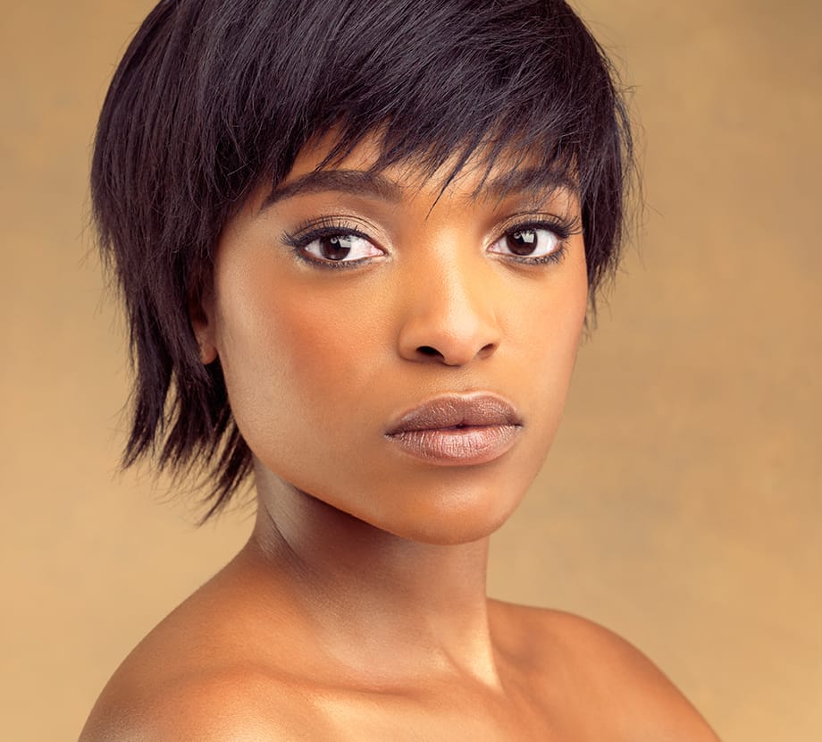 Short haired woman looking into camera with serious expression