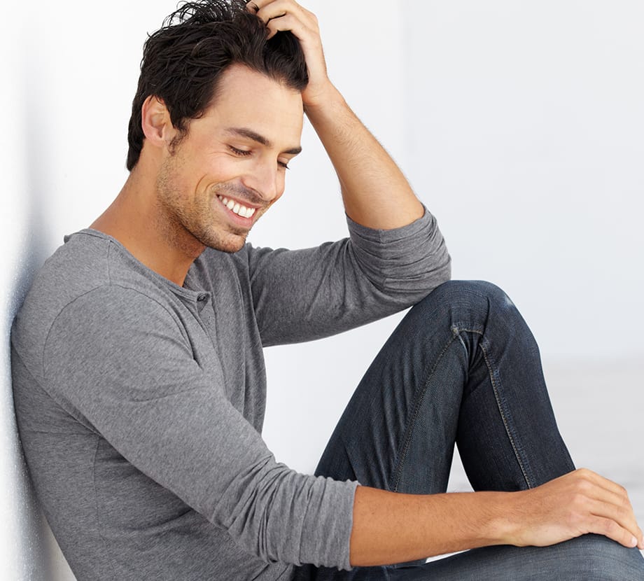 Man sitting on the floor with his elbow on knee