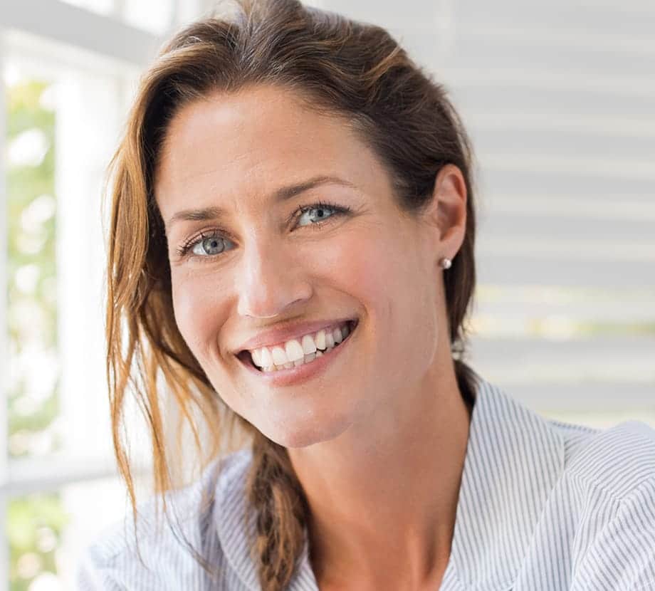 Woman with braided hair, smiling big