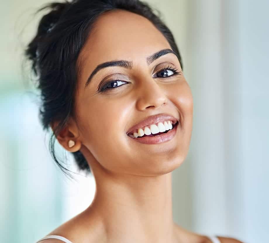 Woman smiling big with her head slightly back