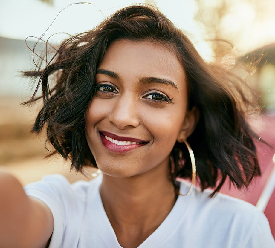 Woman smiling while standing outside