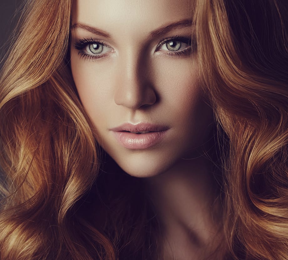 Long haired woman looking off to the side with serious expression