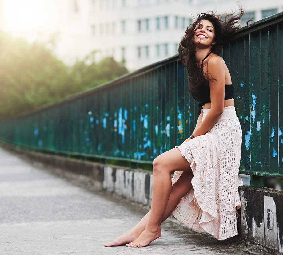 Woman leaning against wall outside