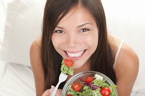 beautiful woman eating salad