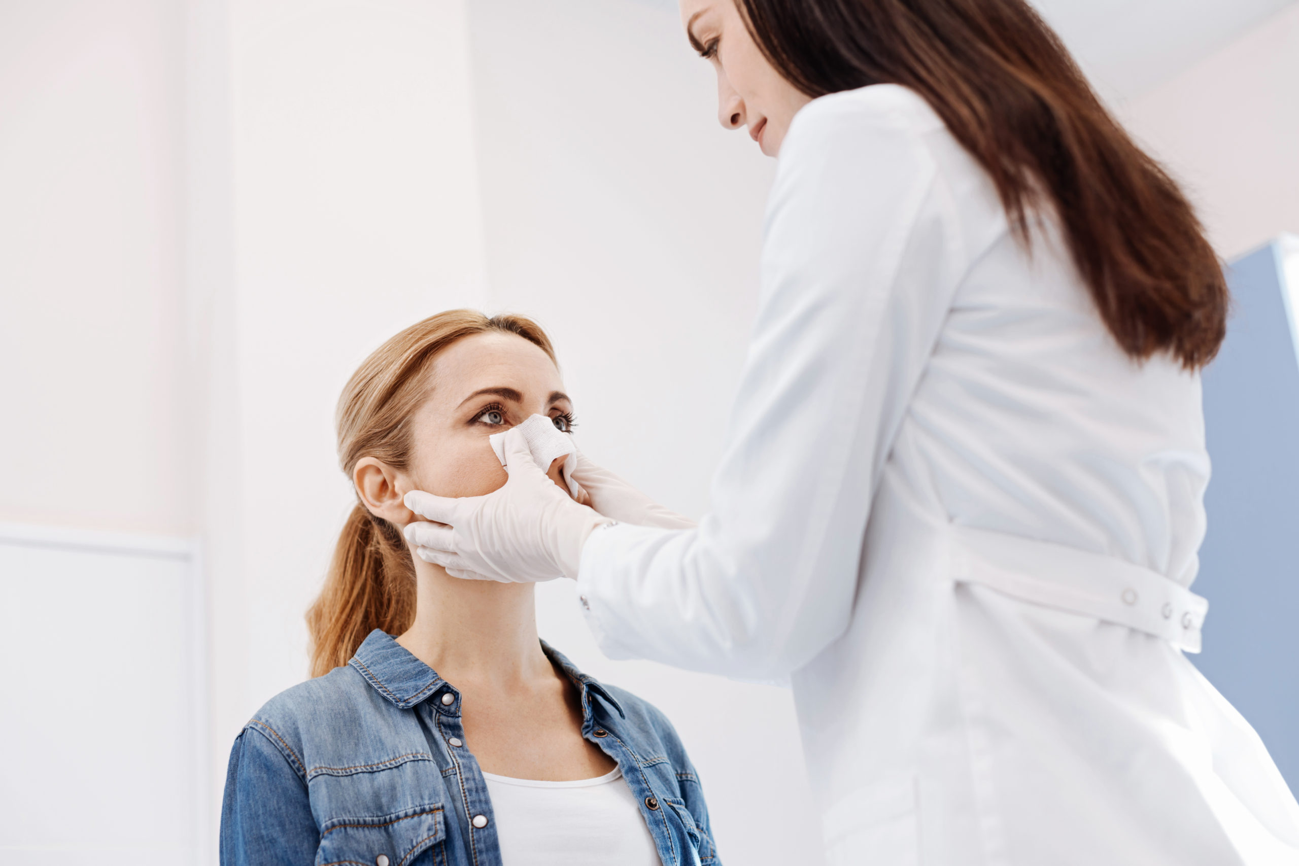 Pleasant female patient reshaping the form of her nose