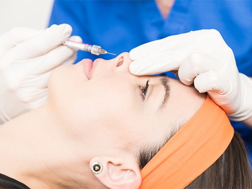 Closeup of charming woman having nose fillers at clinic