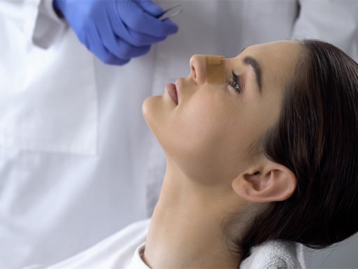 nose doctor examining female patient