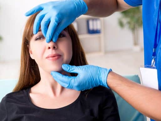 Plastic surgeon consulting woman before rhinoplasty surgery.