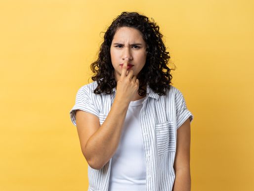 Unhappy woman pressing her nose tip.