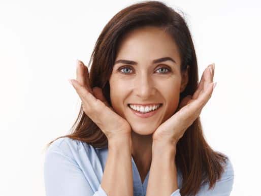 Cheerful woman lifting jowls with her handpalms